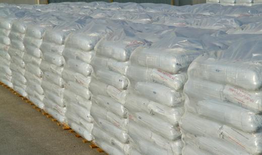 Vertical piles of sandbags is a common method for building a flood wall.