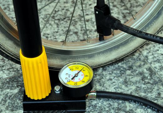 A bicycle pump with an air pressure gauge.