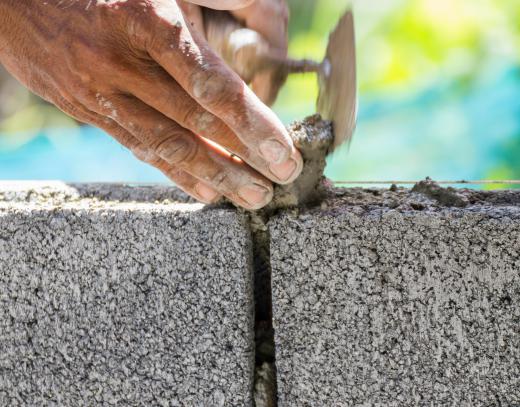 Cinder blocks and mortar can be used to build a cantilever retaining wall.