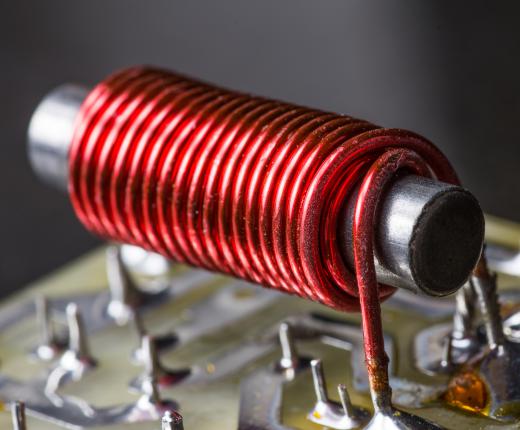An inductor contains a coil of wire which generates a magnetic field when current is applied to it.