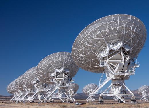 Astrophysicists use radio telescope arrays to track the movements of distant celestial bodies.