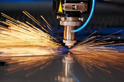 A tunable laser cutter is used to cut a sheet of metal.