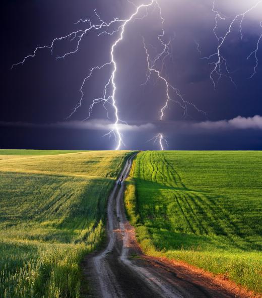 Lightning from a thunderstorm striking a field.