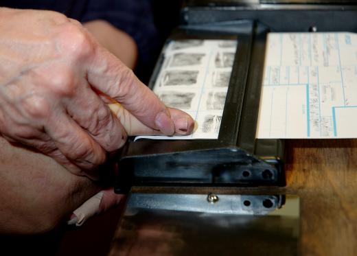 Traditionally, fingerprints were taken by dipping fingers in ink and pressing them on paper cards.