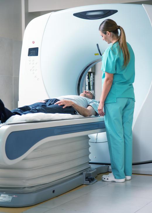 A patient receiving an fMRI will lie on a horizontal stretcher-like platform and slide into a cylindrical cavity.