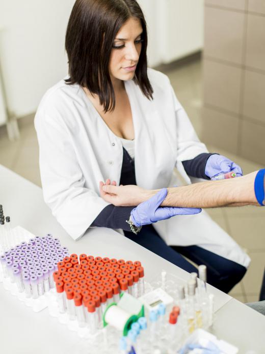 A blood sample may be taken by a phlebotomist in a lab setting.
