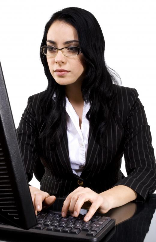 Woman entering data into a computer.