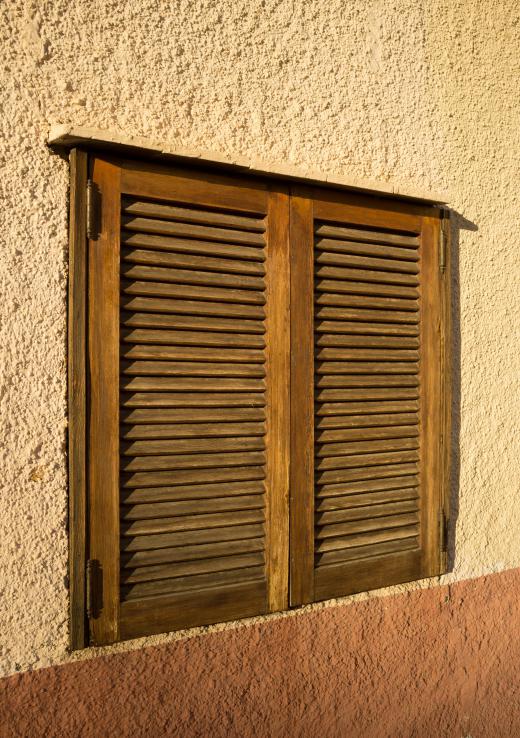 If a developing storm has high winds, close the shutters on the windows.