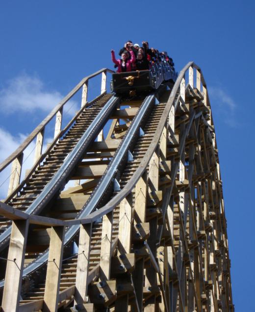 Roller coaster riders experience kinetic energy as they descend.